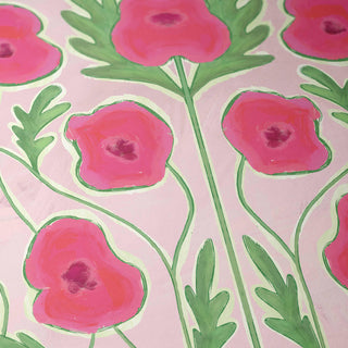 a close-up view of a pattern of pink flowers with green leaves.